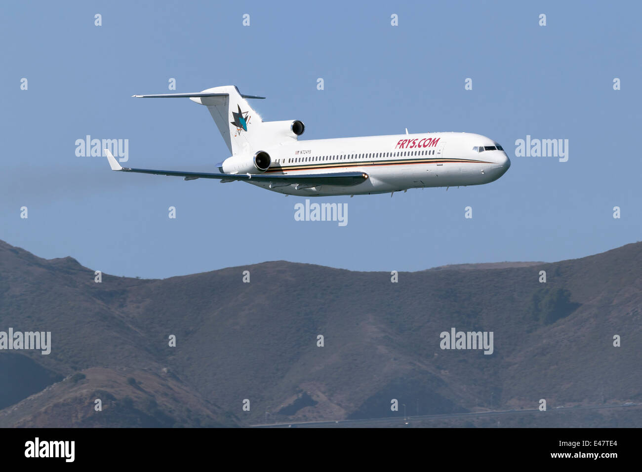 Il San Jose Sharks Hockey del Team di aeromobili, un Boeing 727 (N724YS) effettua un passaggio basso oltre la Baia di San Francisco Foto Stock