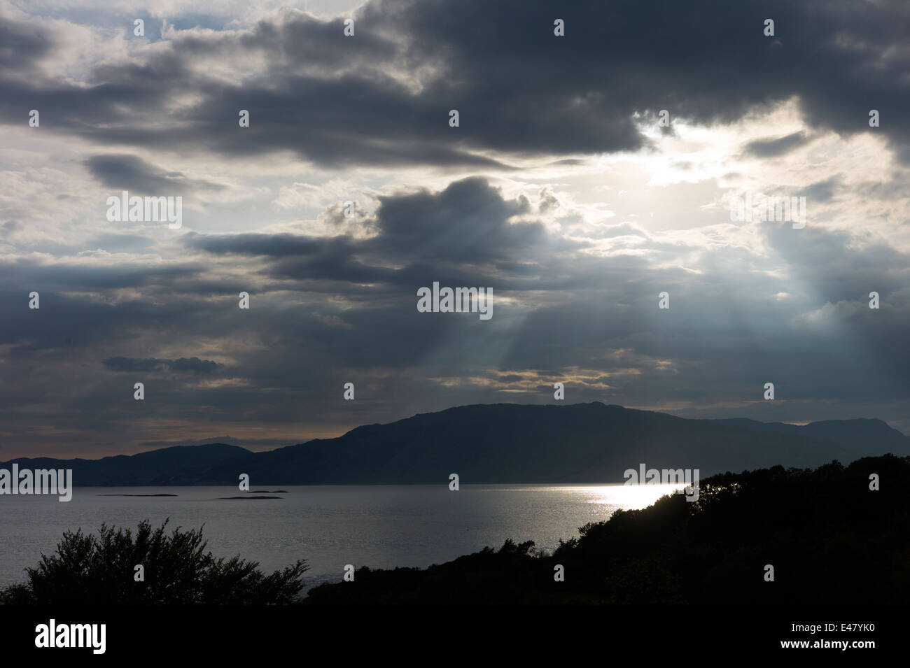 Sunray rottura attraverso le nuvole grigie sul Loch Linnhe in prima serata vicino Strontian, Argyll, nelle Highlands della Scozia Foto Stock