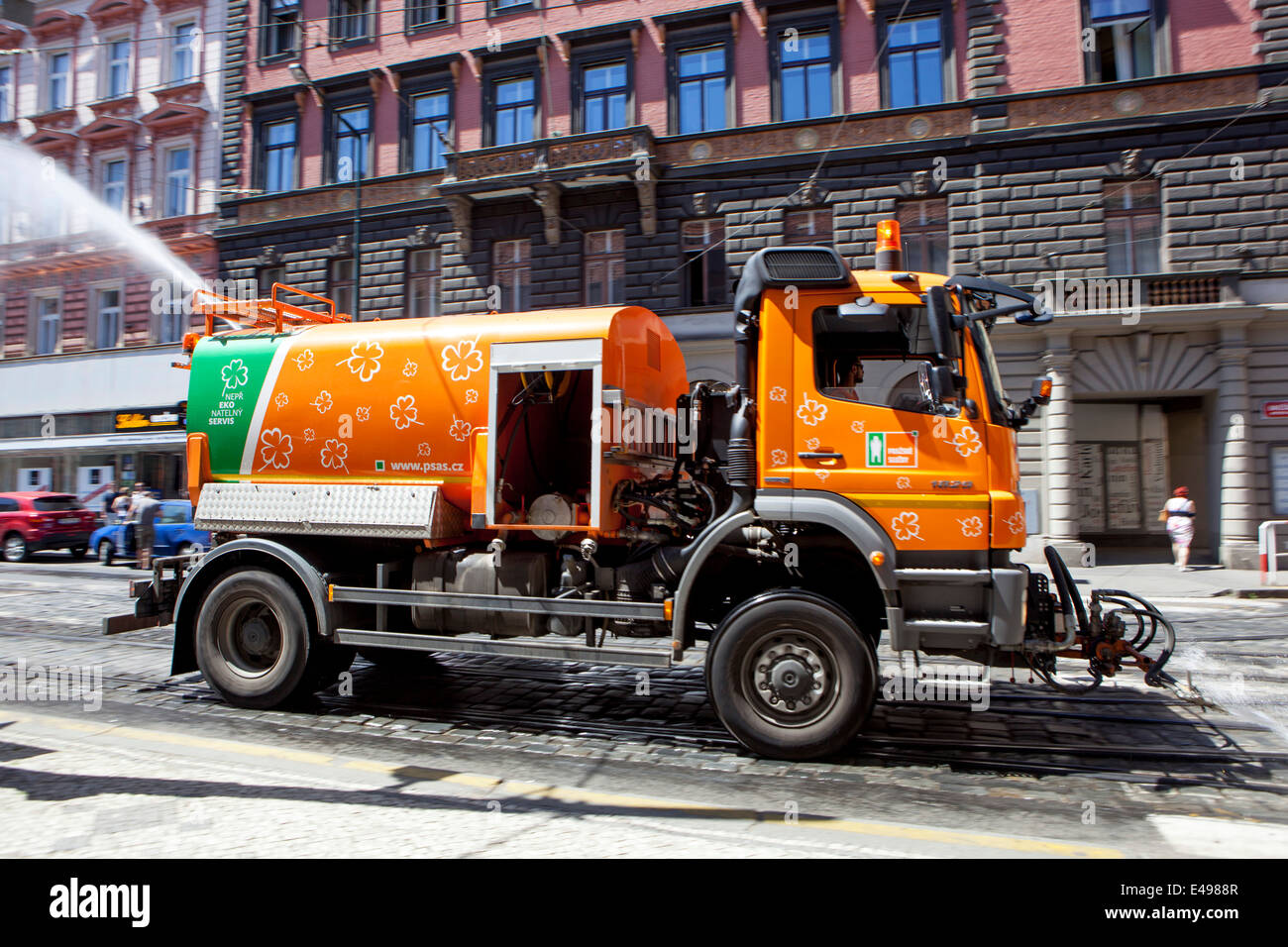 Un'auto a spruzzo sulla strada. Praga calda giornata estiva in città Foto Stock