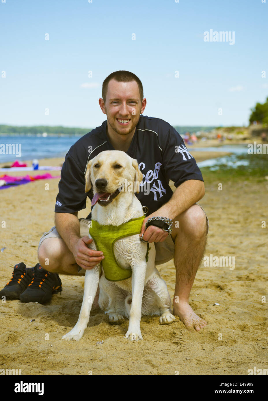 Sands Point, New York, Stati Uniti d'America. 5 Luglio, 2014. Sands Point, New York, Stati Uniti - 5 Luglio 2014 - Giordania, un giallo labrador, e la sua famiglia visitare il litorale sabbioso a Sands Point preservare sulla sponda nord Gold Coast lungo Long Island Sound, durante il giorno di indipendenza weekend. La spiaggia pubblica ha avuto molti visitatori questo Sabato del lungo weekend di vacanza quando soleggiato clima caldo è arrivato dopo il piovoso luglio 4th. © Ann Parry/ZUMA filo/Alamy Live News Foto Stock
