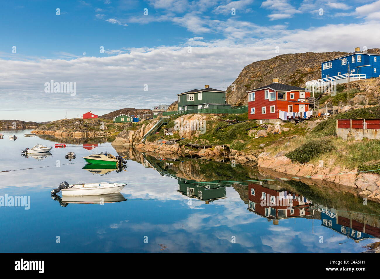 Calma le acque riflettono le case vivacemente colorate in Sisimiut, Groenlandia, regioni polari Foto Stock