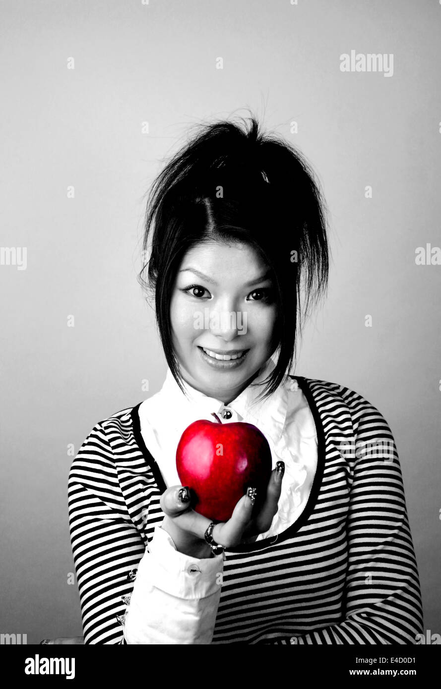 Donna asiatica con Apple. Ella è giapponese e aveva 23 anni al momento di sparare. Foto Stock