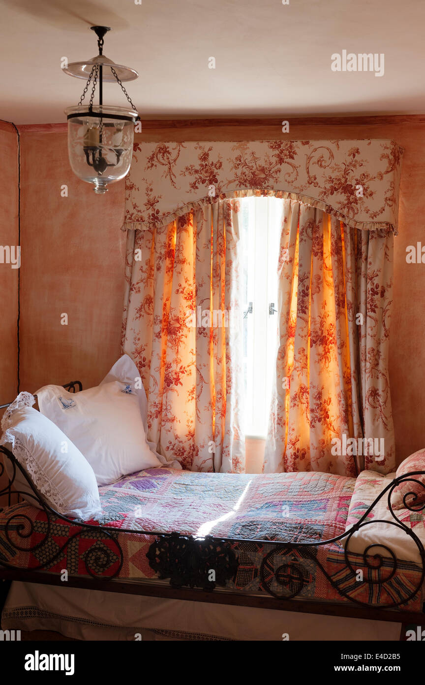 Toile de Jouy tende e mantovane in camera da letto con letto di ferro  battuto e mosaico Foto stock - Alamy