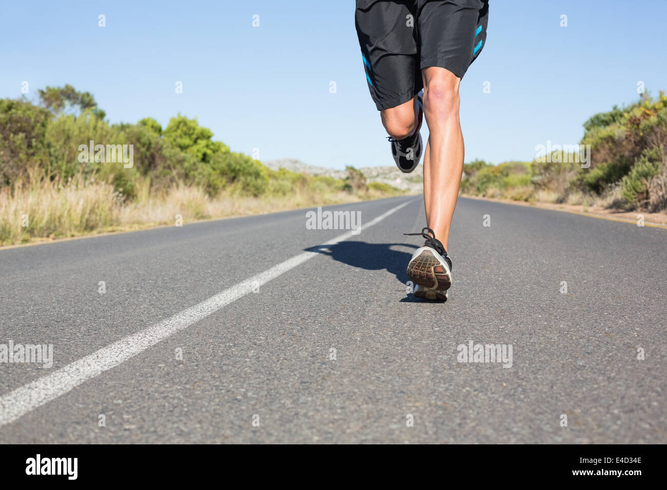 Montare l'uomo jogging sulla strada aperta Foto Stock