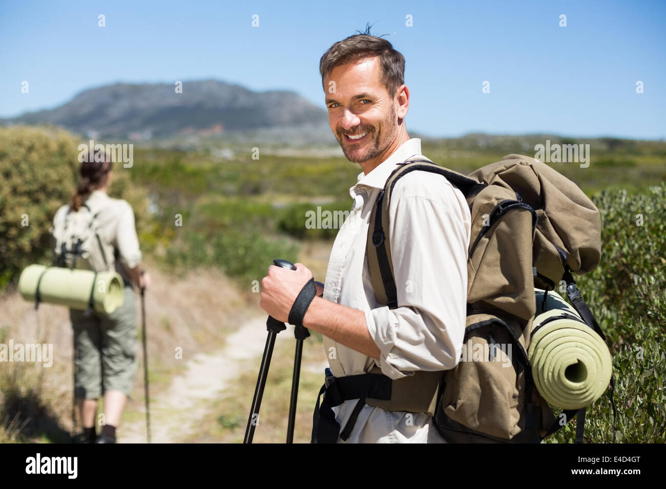 Felice escursionismo giovane camminando sul sentiero del paese Foto Stock