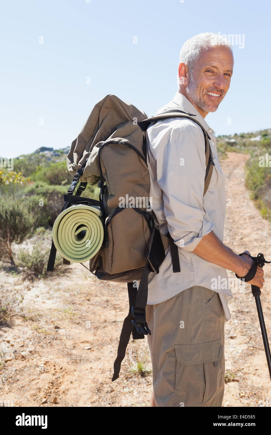 Bello escursionista sorridente in telecamera in campagna Foto Stock