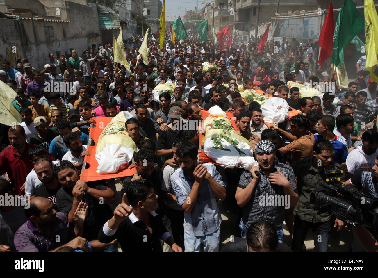 Khan Younis, Striscia di Gaza, la Palestina. 09 Luglio, 2014. I parenti e gli amici di al-Kaware famiglia portano i corpi 7 alla moschea durante il loro funerale in Khan Yunis, nella Striscia di Gaza, il 9 luglio 2014. Il padre, un membro del movimento Fatah e i suoi 6 figli sono stati tutti uccisi il giorno prima in un attacco aereo israeliano che mirate la loro casa. Credito: Abed Rahim Khatib /Pacific Press/Alamy Live News Foto Stock