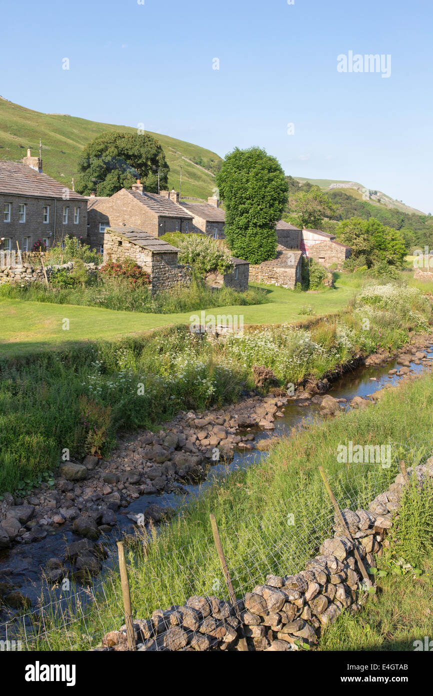 Luce della Sera sopra il villaggio di Thwaite, Swaledale superiore, Yorkshire Dales National Park, England, Regno Unito Foto Stock