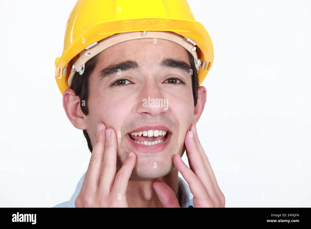 Lavoratore edile con mal di denti Foto Stock