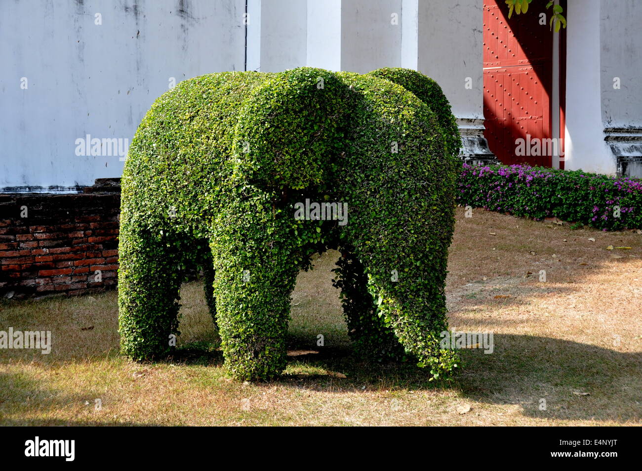 LOPBURI, Thailandia: Topiaria da un elefante sorge accanto ad una delle porte di ingresso al Wat Phra Narai Rachanivej Foto Stock