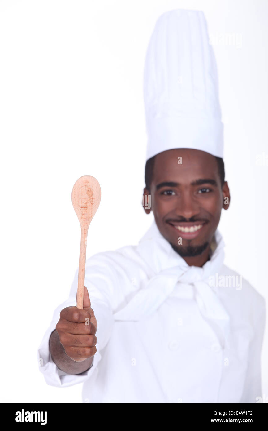 Giovane cuoco mostra il cucchiaio Foto Stock