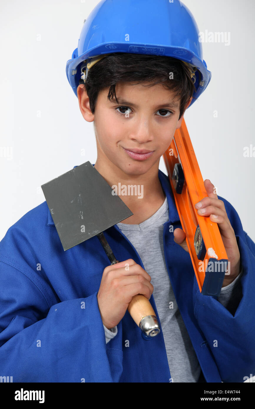 Junior vuole essere un muratore. Foto Stock