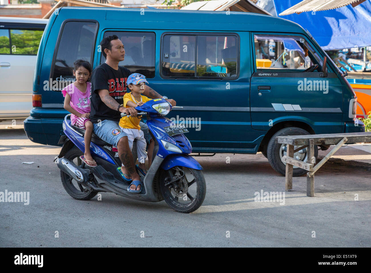 Jimbaran, Bali, Indonesia. Padre e figli sulla moto, caschi n. Foto Stock