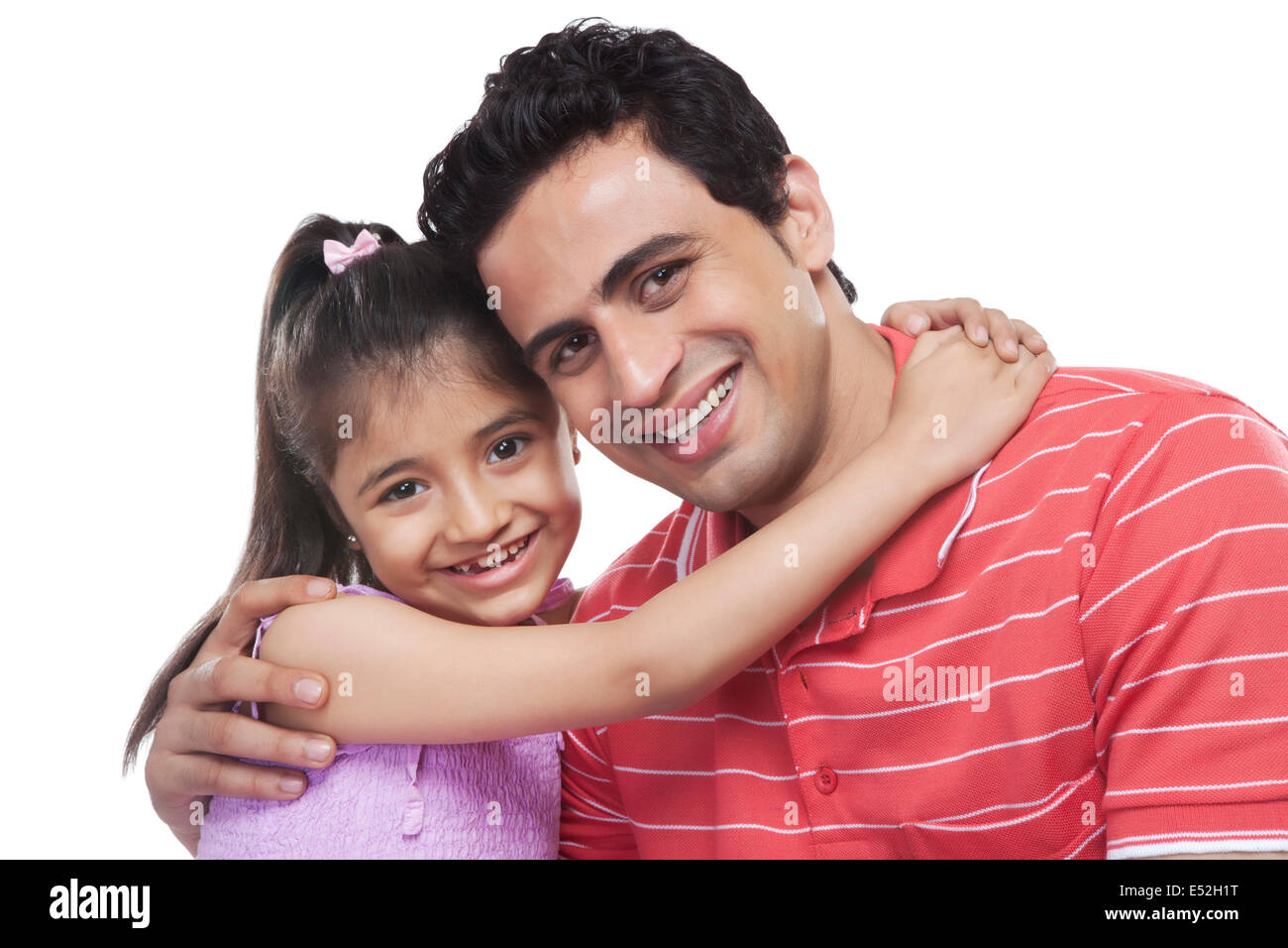 Ritratto di felice figlia abbracciando padre contro uno sfondo bianco Foto Stock