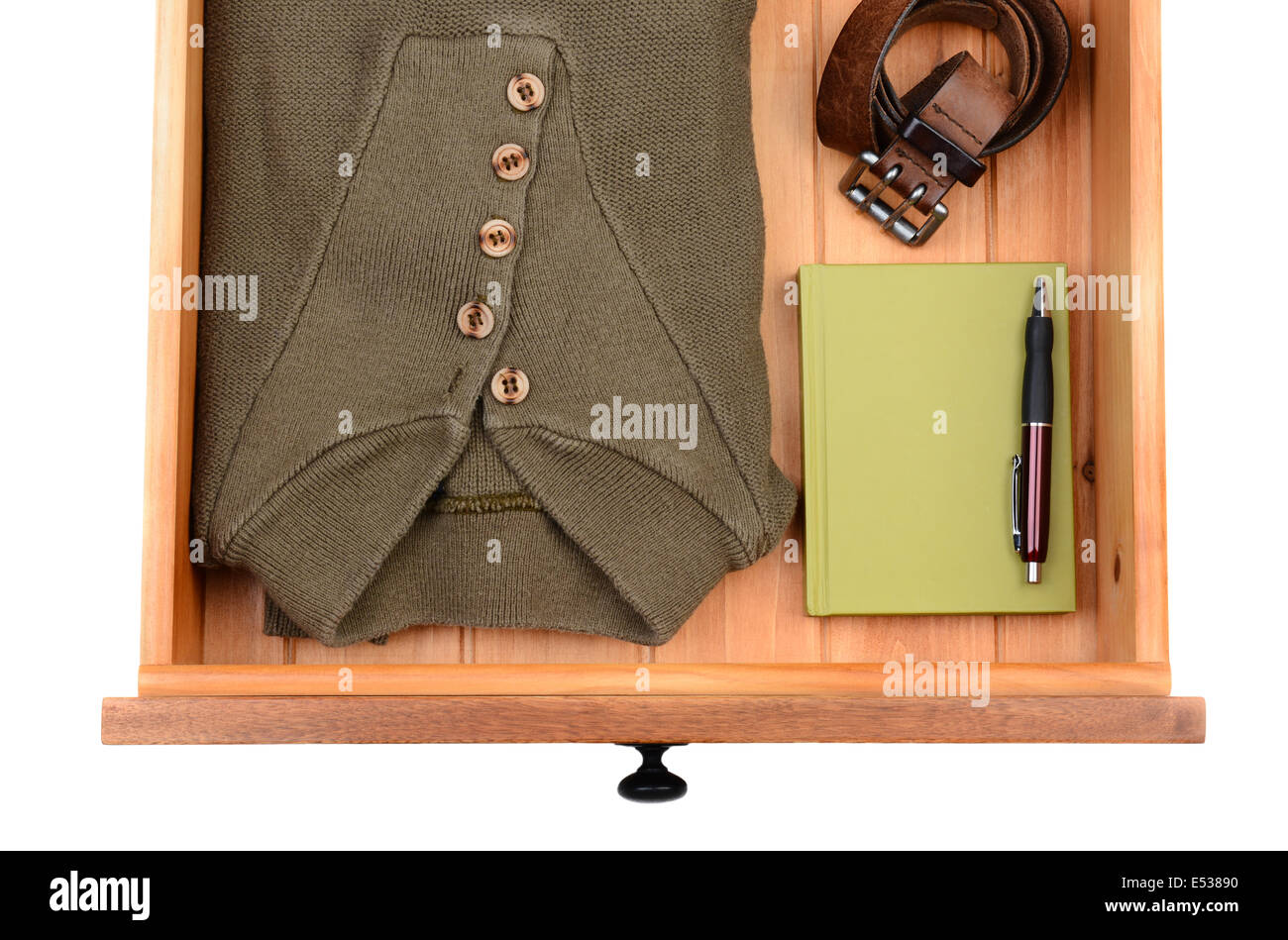 Alta angolazione di un maglione, cinghia, libro e penna in un cassetto. Formato orizzontale isolato su bianco. Foto Stock