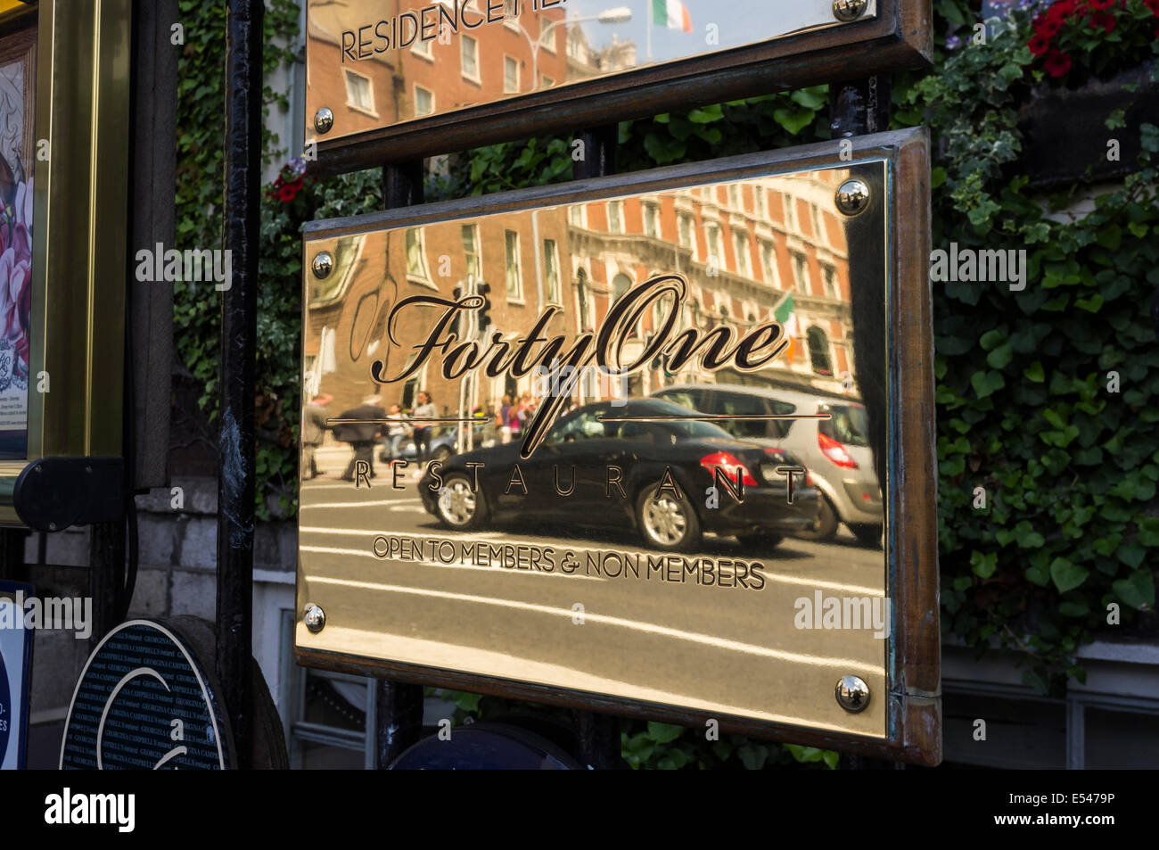 La riflessione di un automobile Mercedes e Shelbourne Hotel nella placca in ottone fuori del ristorante Forty One in St Stephens Green, Dub Foto Stock