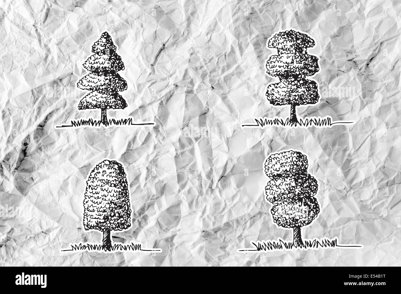 Set di alberi con foglie su carta sgualcita Foto Stock