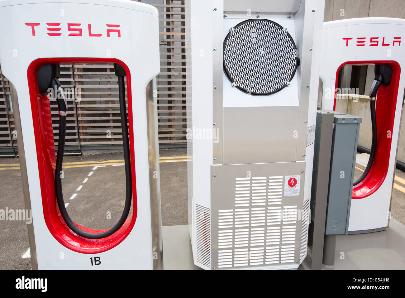 Una Tesla veicolo elettrico con stazione di ricarica presso il palazzo di cristallo che è il primo edificio nel mondo che ha ottenuto un eccezionale BREEAM (BRE Valutazione Ambientale) metodo di classificazione e un LEED (Leadership in Energy and Environmental Design) rating di platino. Londra, Regno Unito. Foto Stock