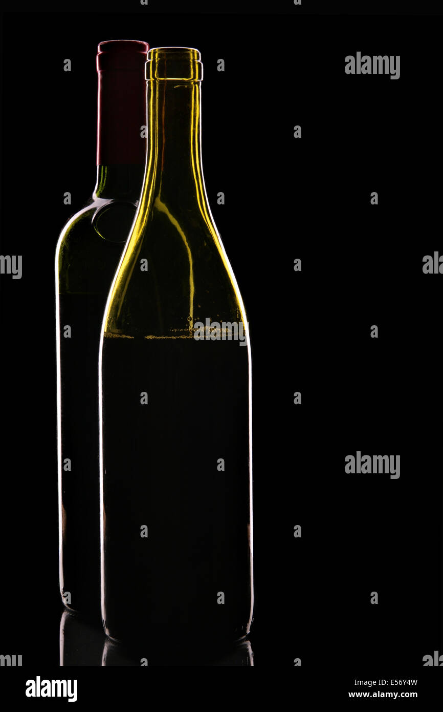 Still-life con due bottiglie di vino rosso su sfondo nero Foto Stock