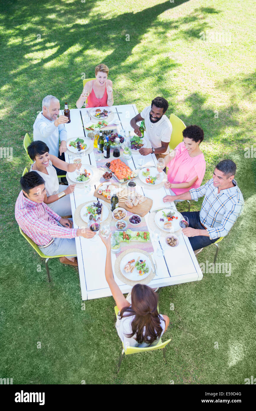 Gli amici di mangiare insieme a tavola all'aperto Foto Stock