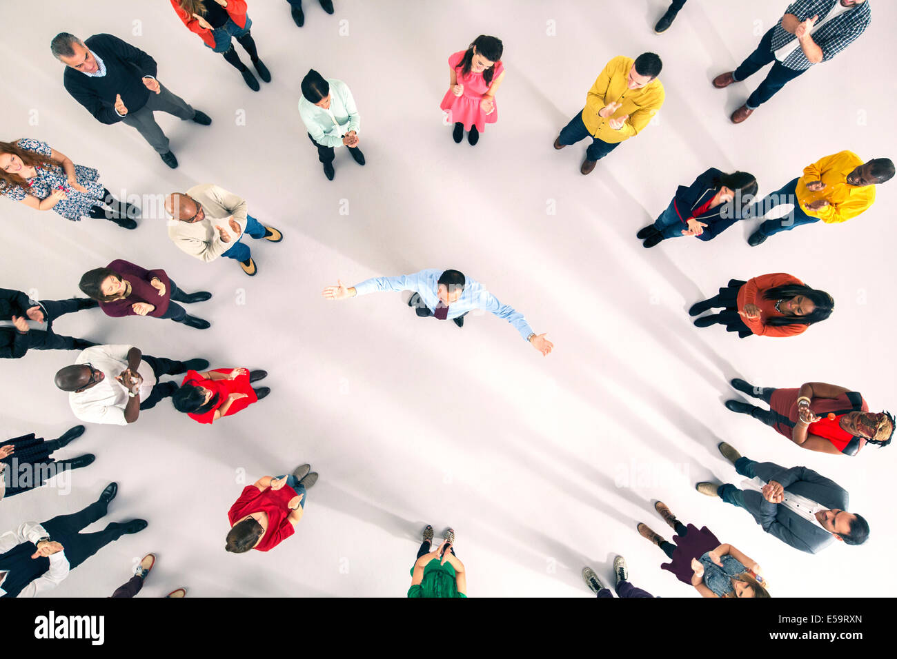 La folla intorno all uomo d affari con le braccia aperte Foto Stock