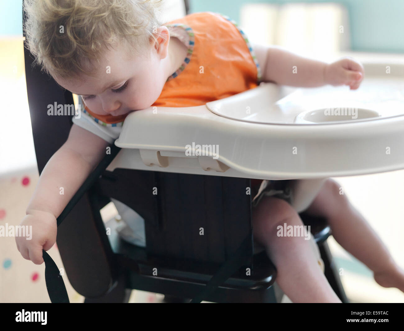 Baby girl giocando in sedia alta Foto Stock