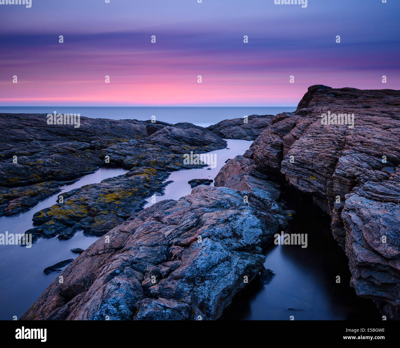 Vista della costa rocciosa durante il tramonto Foto Stock