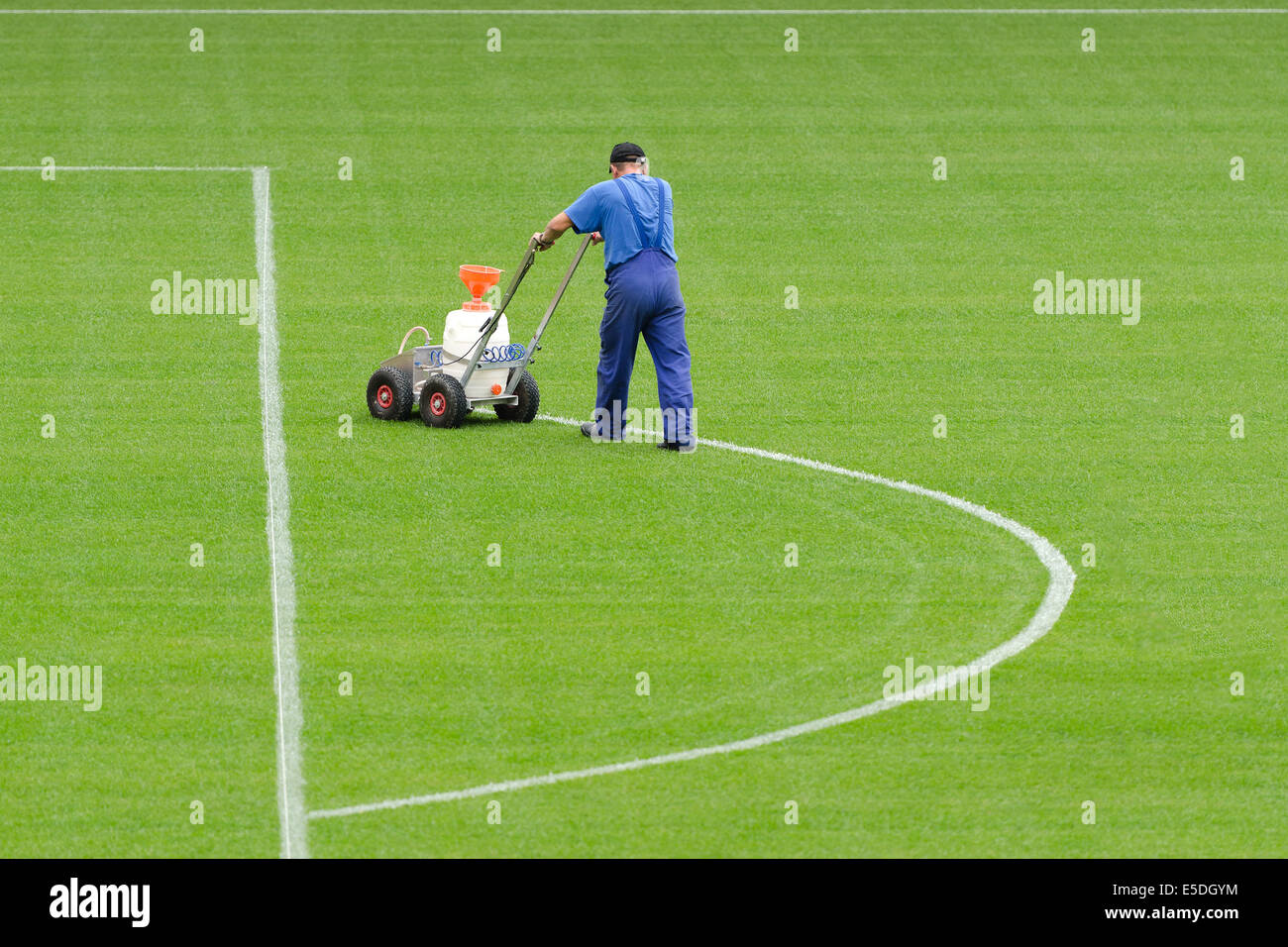 Un uomo linea di verniciatura su uno stadio di calcio. Foto Stock