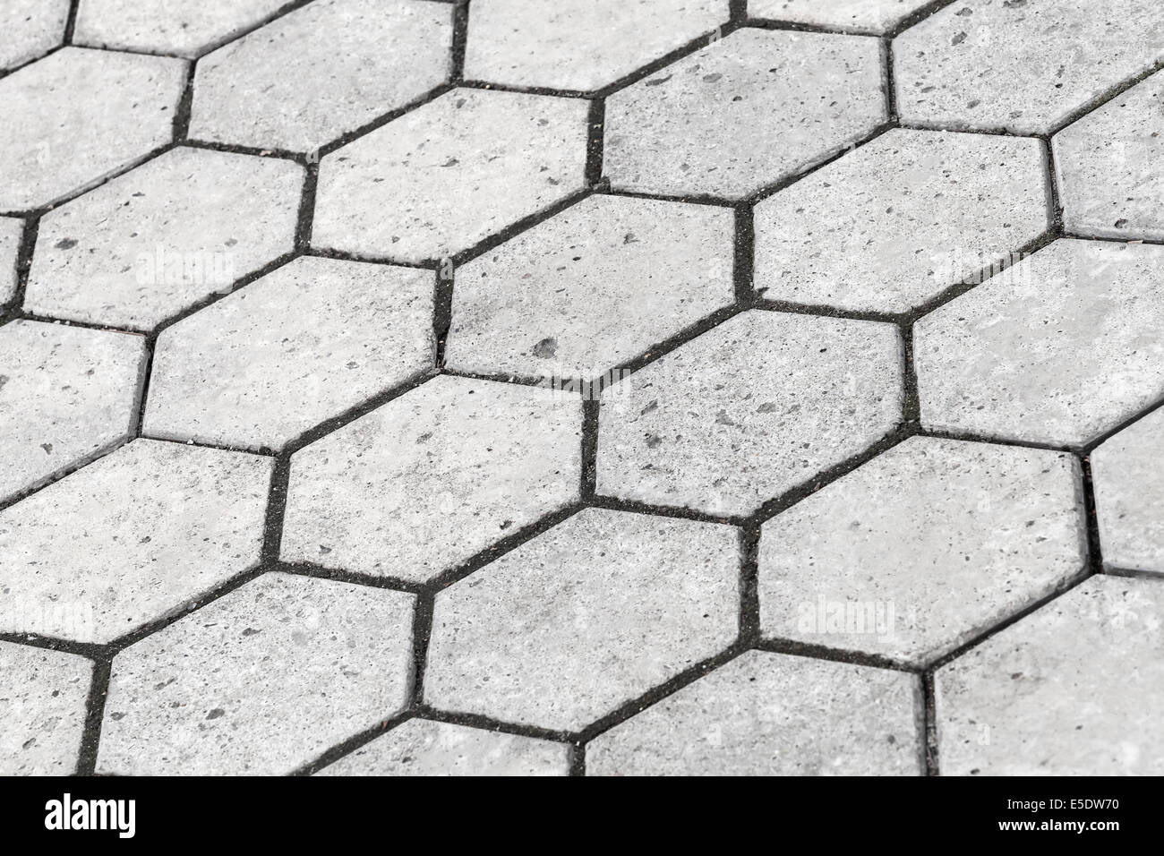 Texture di sfondo di colore grigio a forma di nido d'ape strada acciottolata Foto Stock