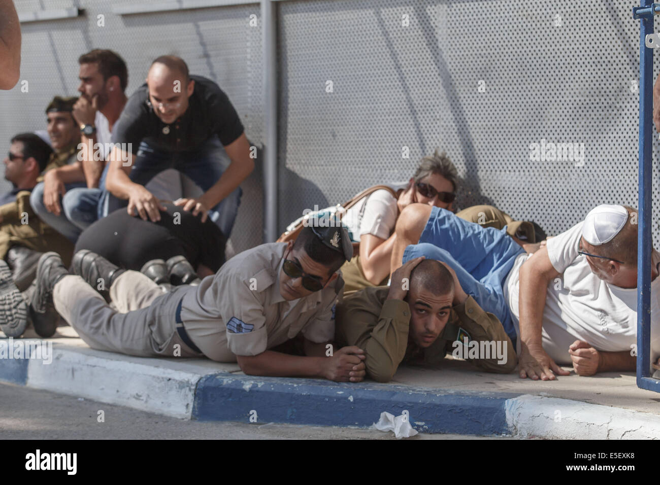 Frontiera Gaza. 29 Luglio, 2014. I residenti israeliani prendere la copertura da un razzo attacco dalla striscia di Gaza durante i funerali del soldato israeliano Caporale Meidan Maymon Biton presso il cimitero del sud della città israeliana di Netivot, il 29 luglio 2014. Alti ufficiali israeliani Martedì negato U.S. Il segretario di Stato John Kerry rivendicazione che Israele aveva chiesto agli Stati Uniti di promuovere un cessate il fuoco umanitario nella Striscia di Gaza. © JINI/Xinhua/Alamy Live News Foto Stock