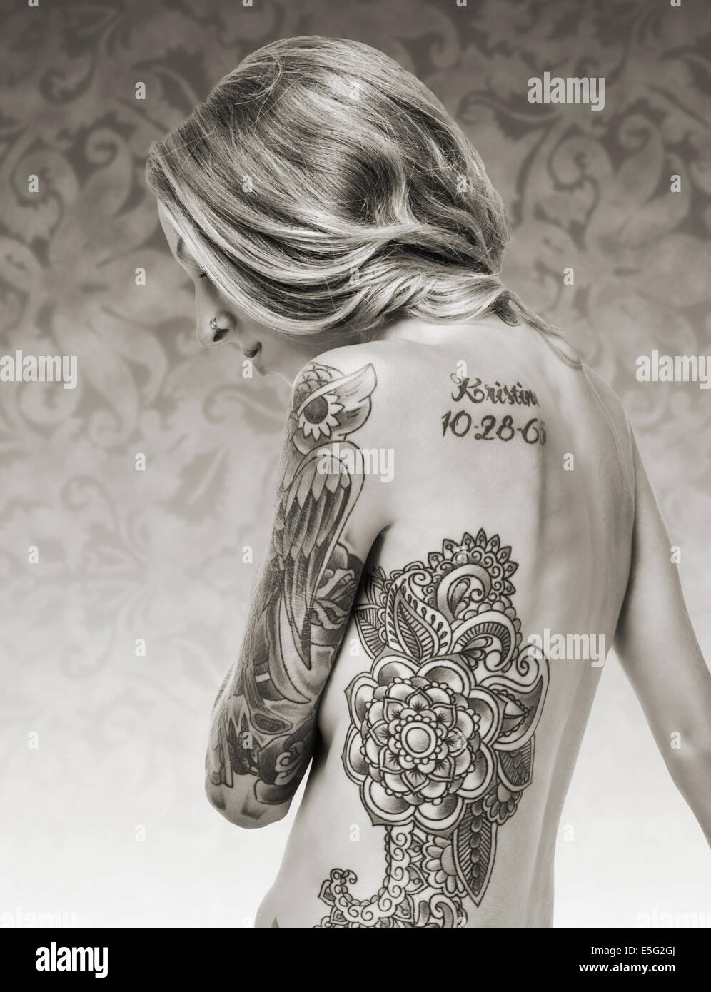 In bianco e nero ritratto in studio di tatuaggi e piercing su un attraente,  slanciato, nudo dai capelli biondi giovane donna Foto stock - Alamy