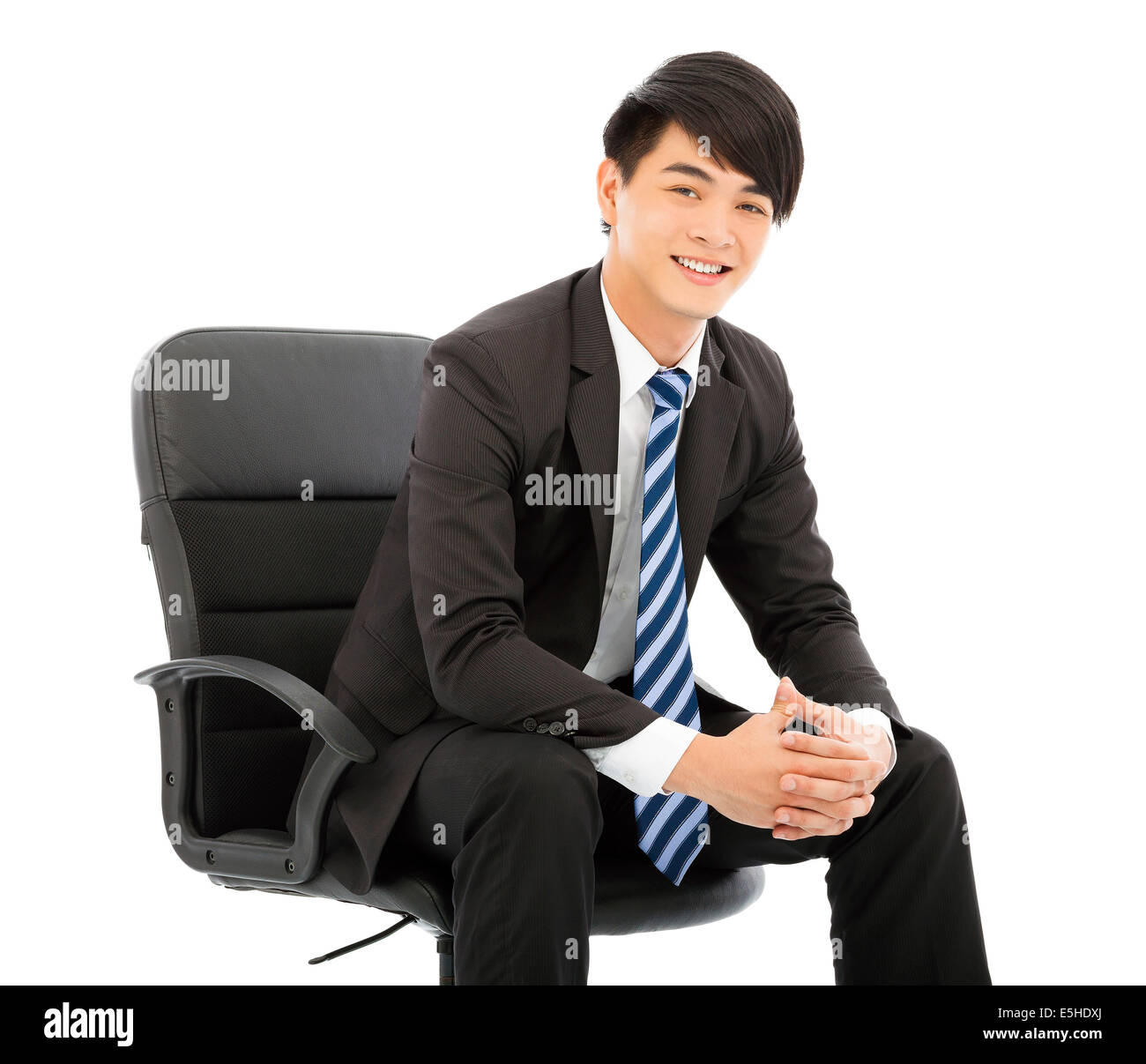 Sorridente imprenditore giovane seduto in una sedia Foto Stock