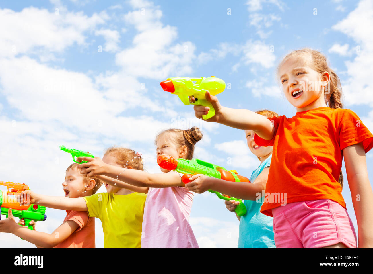 Cinque bambini giocano con le pistole di acqua Foto Stock