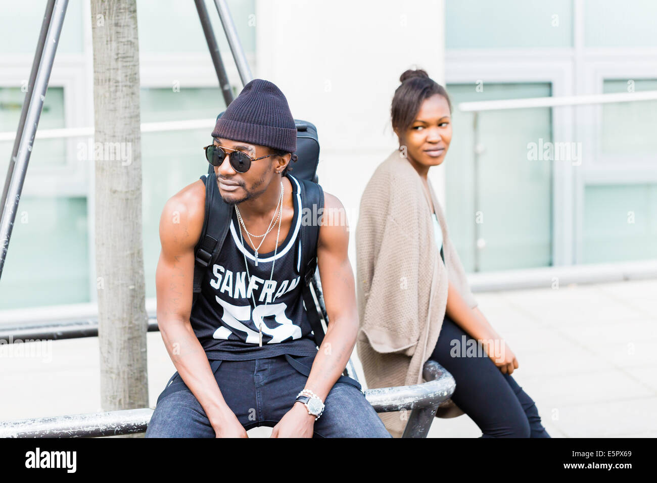 African uomo seduto con la fidanzata in città Foto Stock