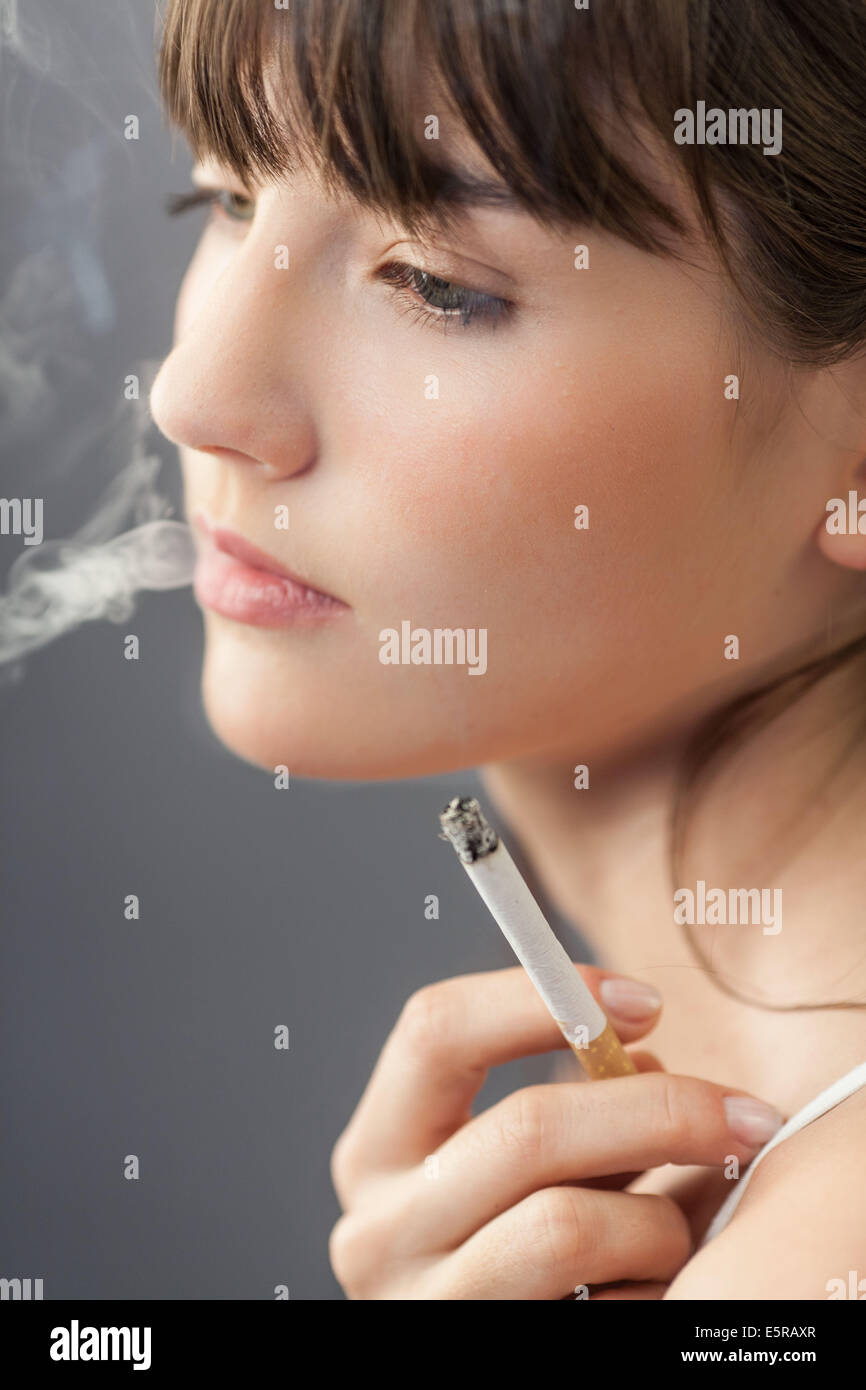Donna di fumare una sigaretta. Foto Stock