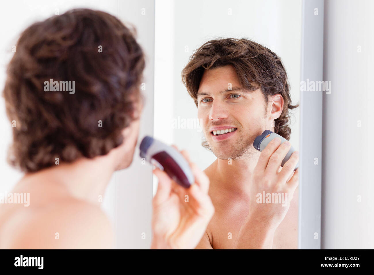L'uomo la rasatura con una rasatura elettrica. Foto Stock