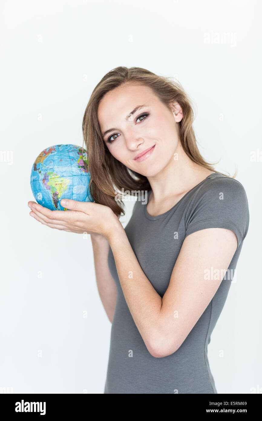 Donna che mantiene una mappa del mondo. Foto Stock
