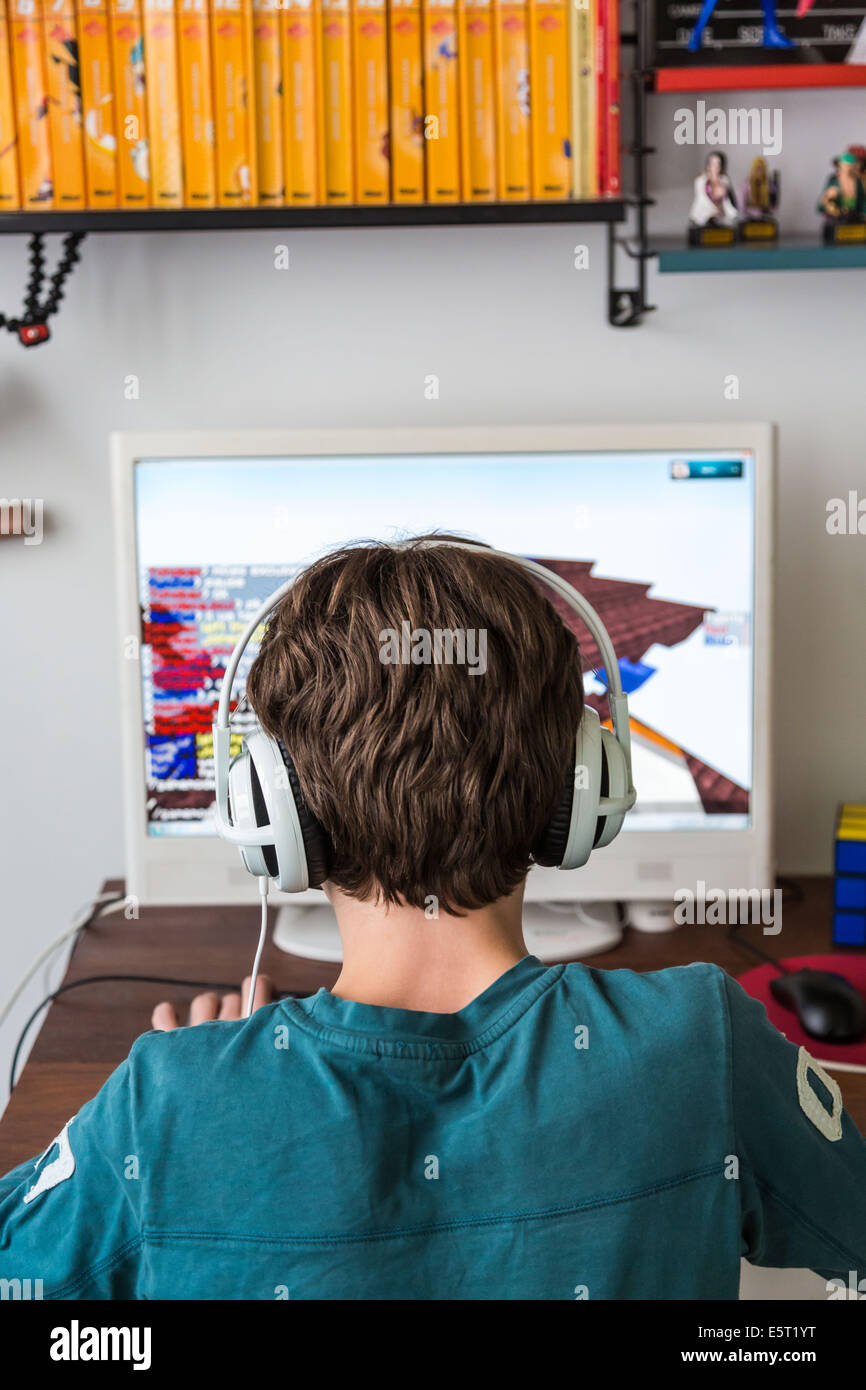Adolescente giocando Minecraft gioco multiplayer online (MMO). Foto Stock