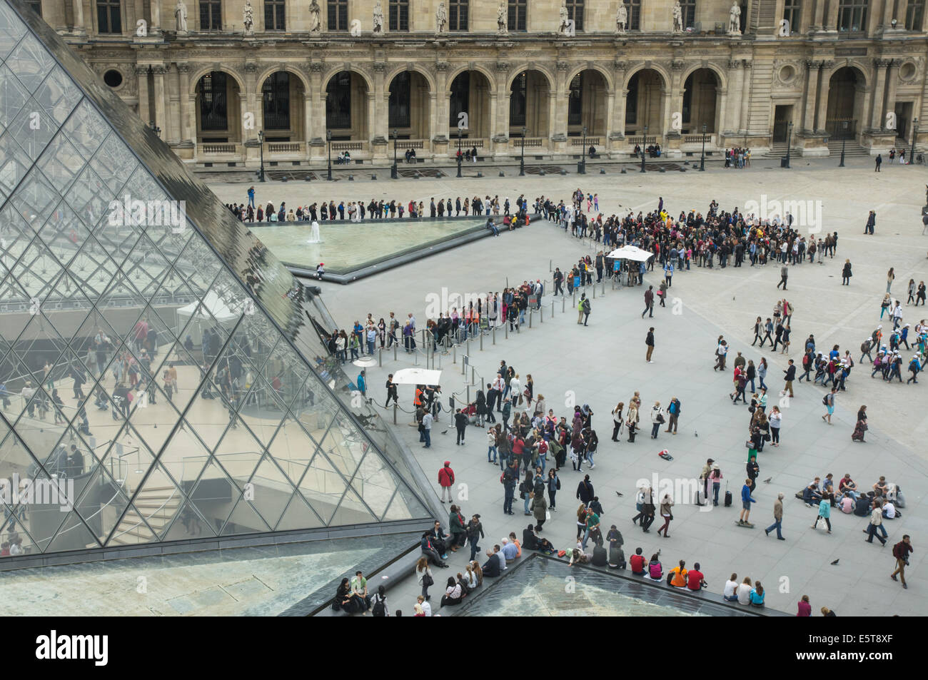 I visitatori e i turisti fanno la fila alla piramide di vetro, ingresso al Museo del Louvre di Parigi, Francia Foto Stock