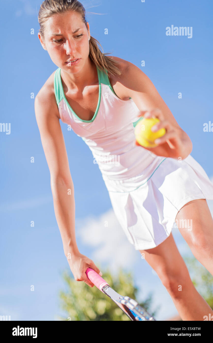 Giovane donna giocando a tennis Foto Stock