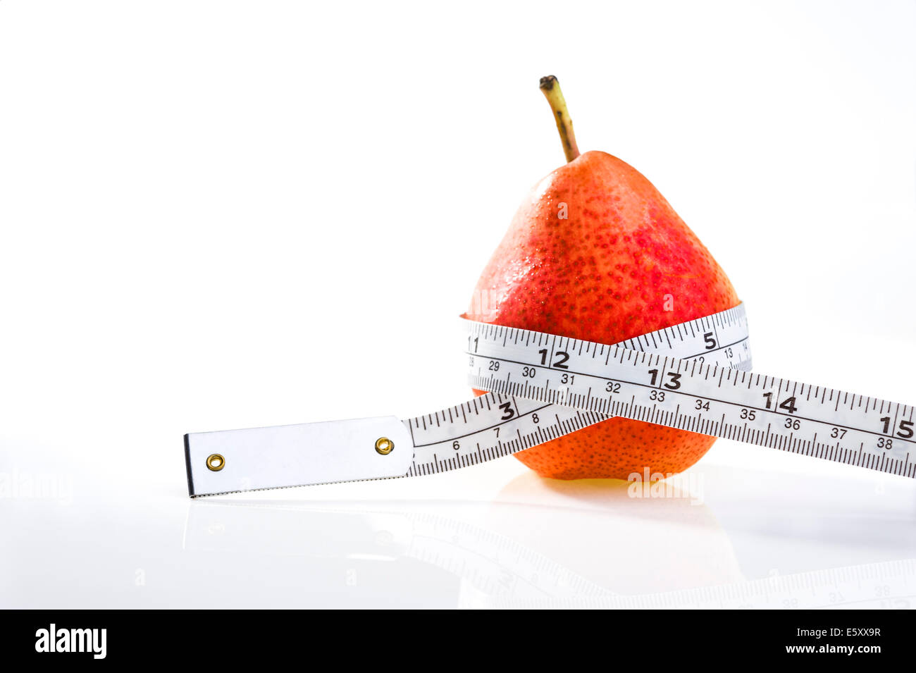 Pera rosso con nastro di misurazione.L'obesità, la perdita di peso, dieta. Foto Stock