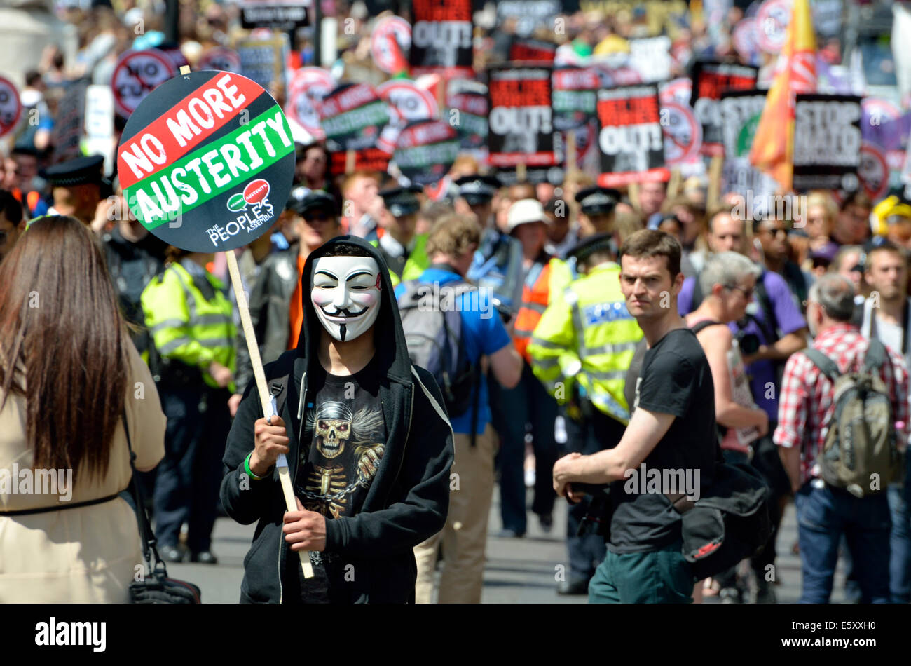 Protester sulla maschera di V con nessuna targhetta tagli ad un anti-austerità marzo a Londra, 2014 Foto Stock