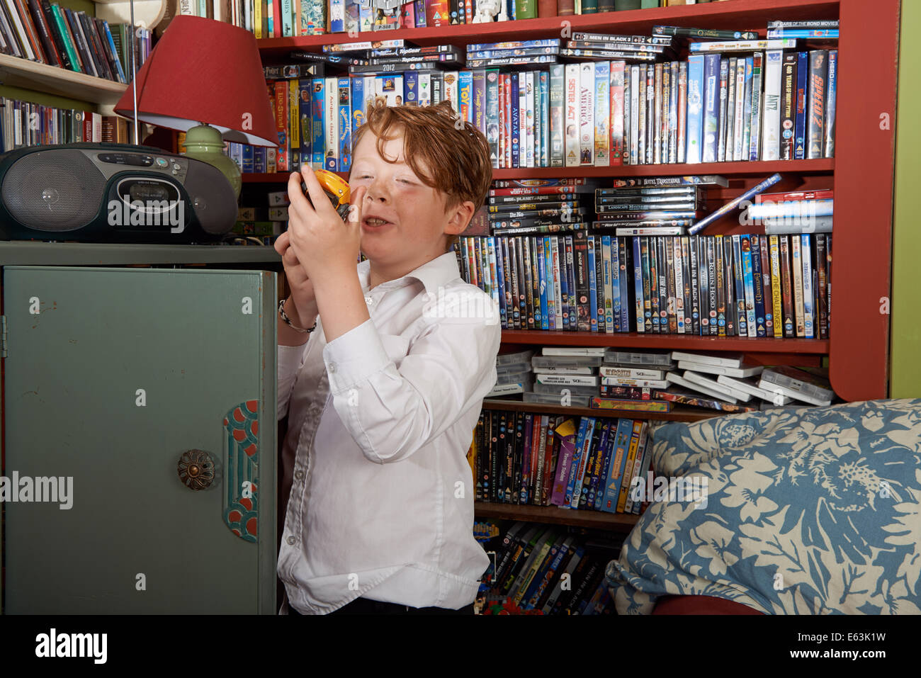 9 anno di old boy a casa dopo la scuola a giocare con una macchina giocattolo Foto Stock