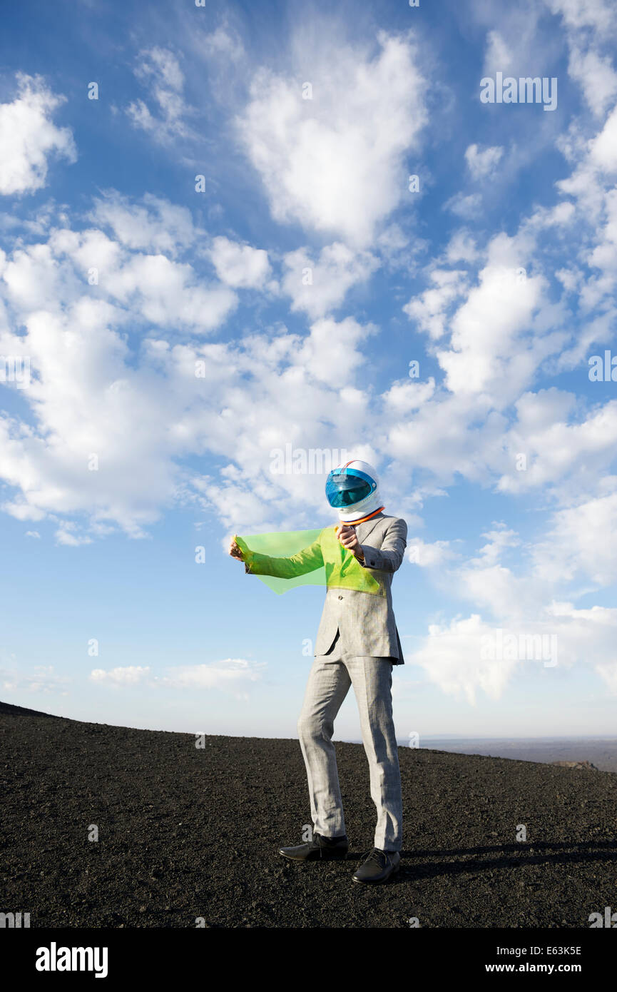 Explorer imprenditore nel paesaggio lunare legge mappa elettronica sul futuro della tecnologia display flessibile tablet Foto Stock