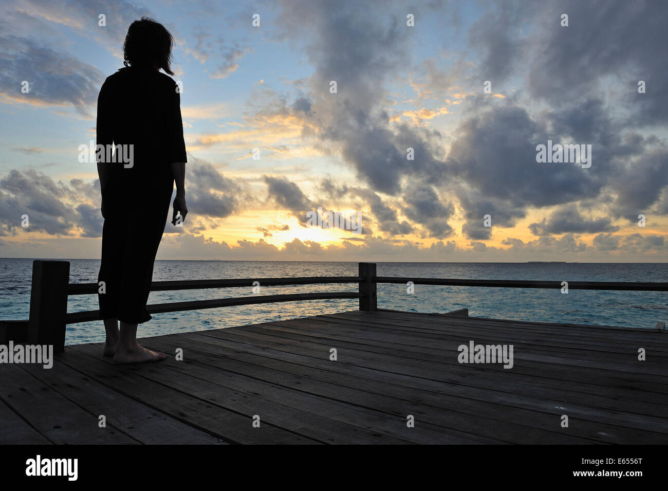 Silhouette di donna - donna contemplando il sunrise, isola del Borneo, Stato di Sabah, Malesia Foto Stock