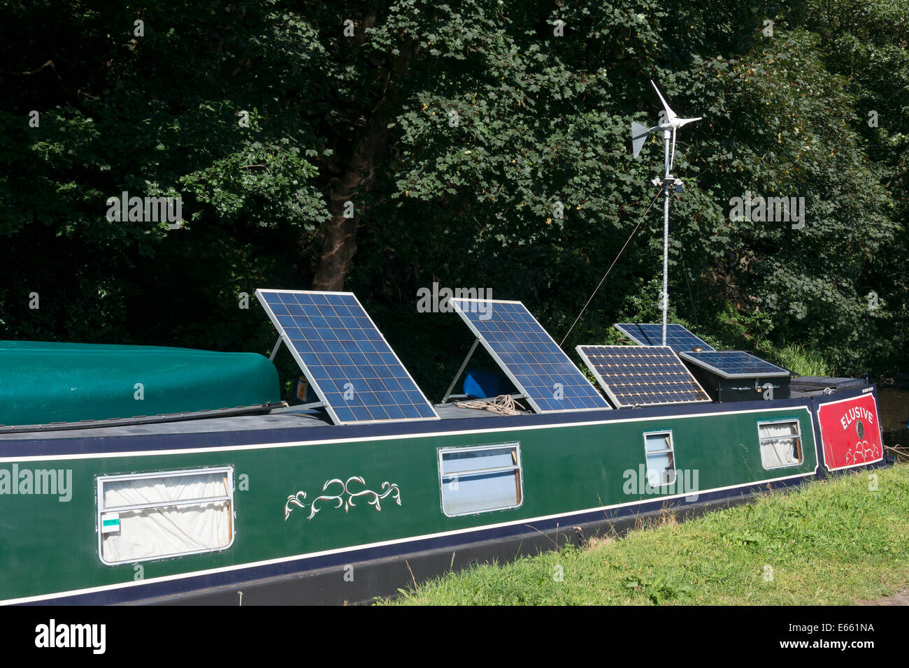 Pannelli solari e generatore a vento sulla cima di un narrowboat, Sowerby Bridge, West Yorkshire Foto Stock