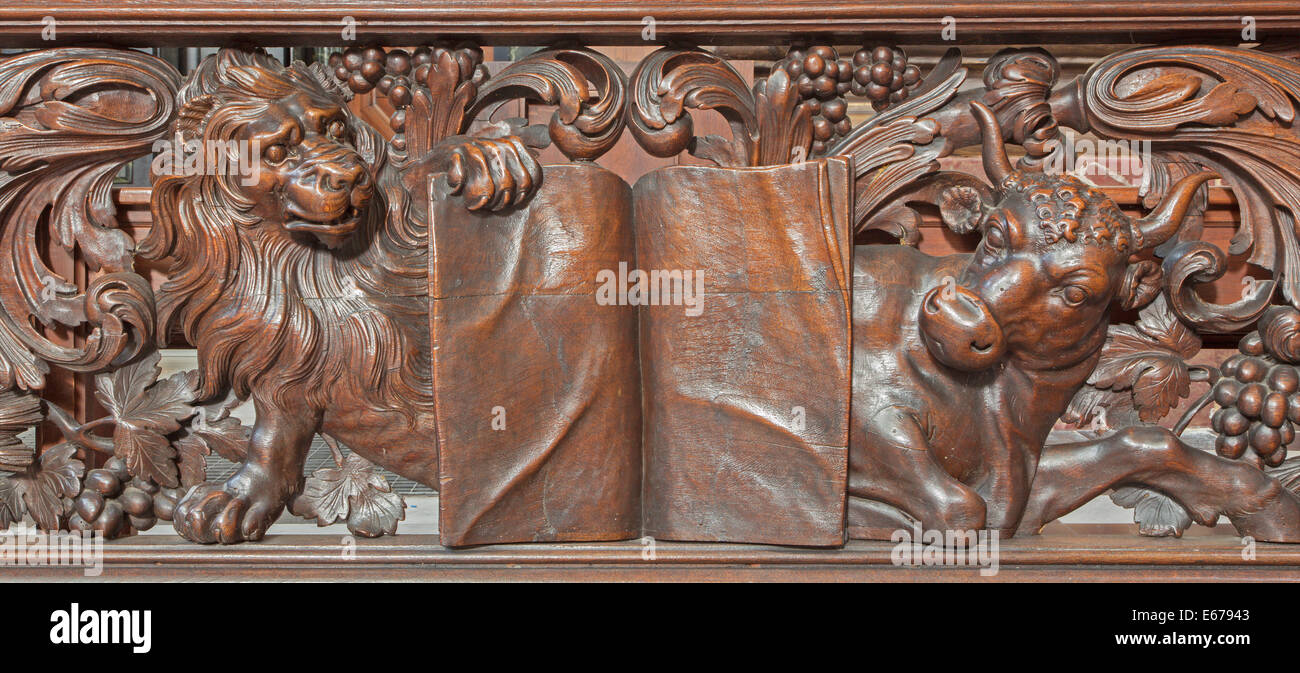 BRUGES, Belgio - 13 giugno 2014: rilievo scolpite di Lion e bull come evangelista st. Contrassegnare e st. Luca nel Karmelietenkerk Foto Stock
