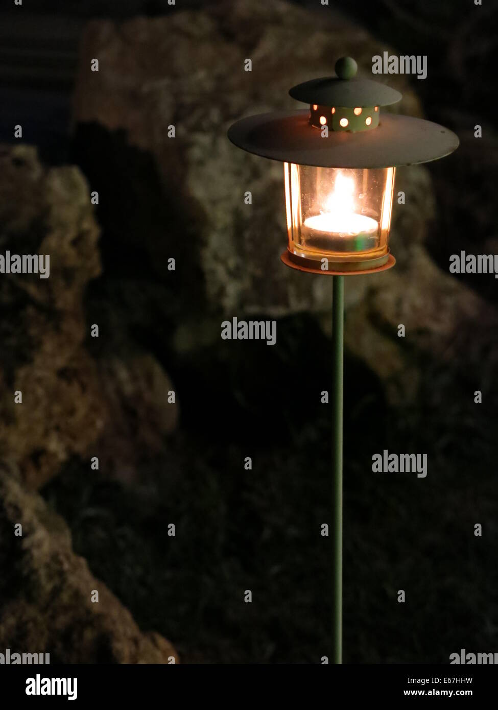 Immagine di una candela illuminata che decorano un giardino. Foto Stock
