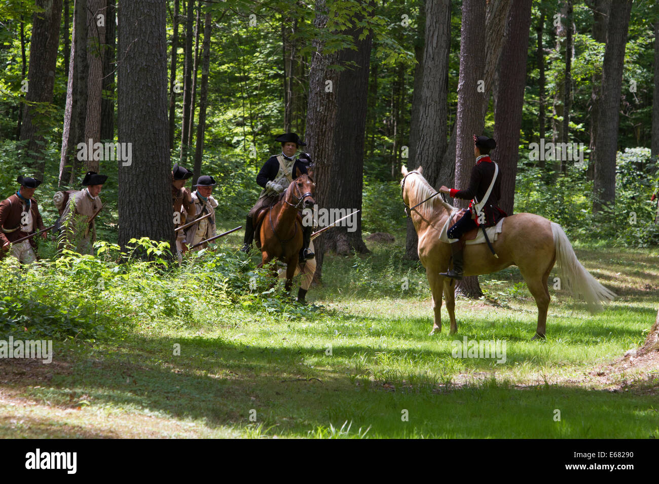 La guerra rivoluzionaria americana reenactors nella foresta la preparazione per la battaglia. Foto Stock