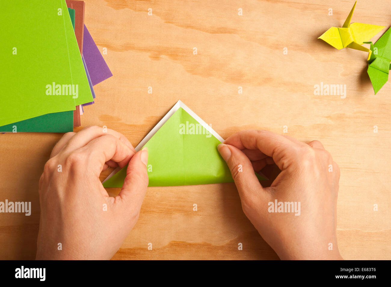 Donna piegando la carta per origami Foto Stock